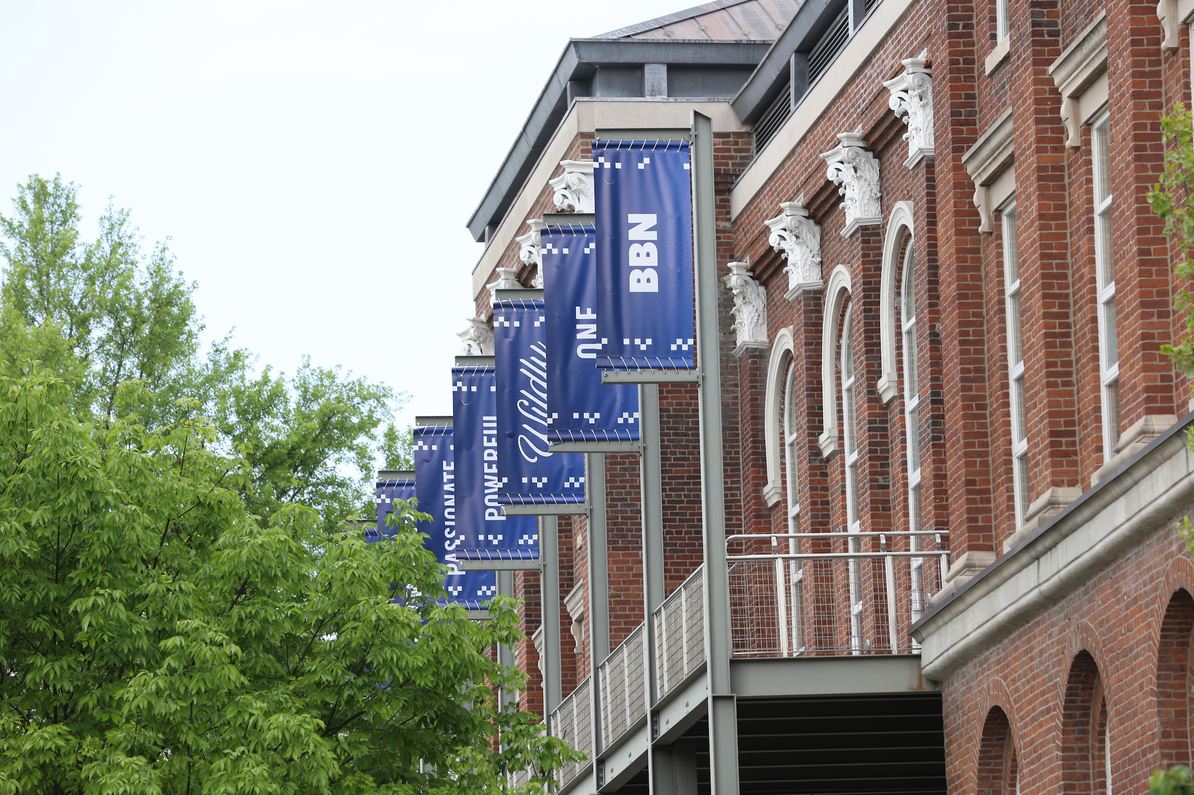 Photo of blue Wildly Possible banners on the back of Main Building