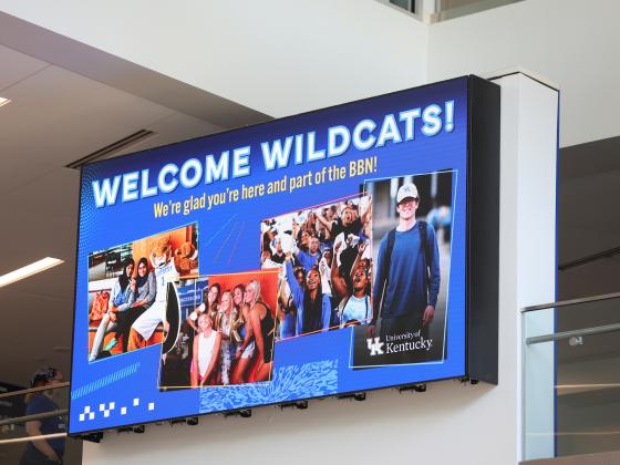 Photo of digital signage screen above the social staircase in the Gatton Student Center